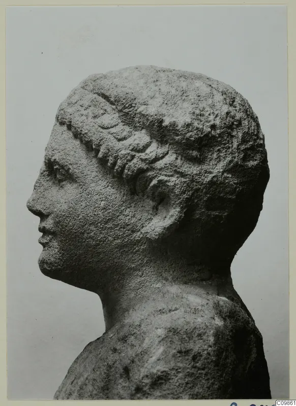 Head and shoulders of a sculpted figure in profile, facing left, with wavy hair bands across the forehead.