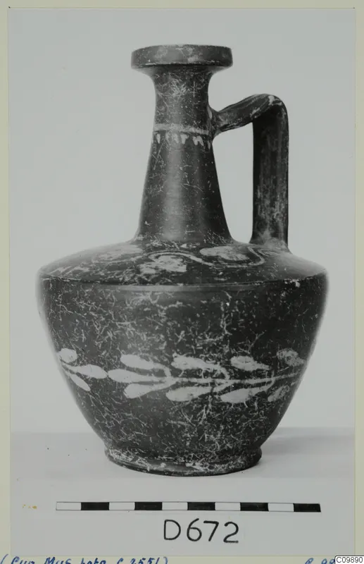 Dark-surfaced jug with a single loop handle and white painted leaf pattern on the body, Cypro-Hell.I pot