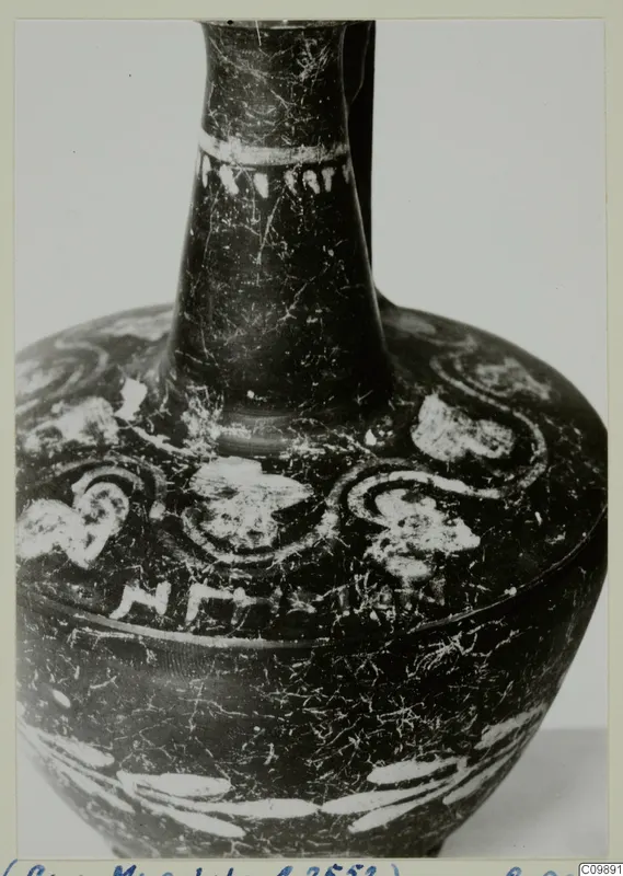 Dark-surfaced pottery bottle with a long narrow neck and white painted spiral and band decoration