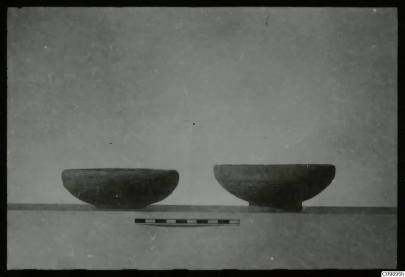 Two pottery bowls side by side on a grey surface, with a scale bar in front, from Ajii Omologitades, Politiko and Limassol Oasis