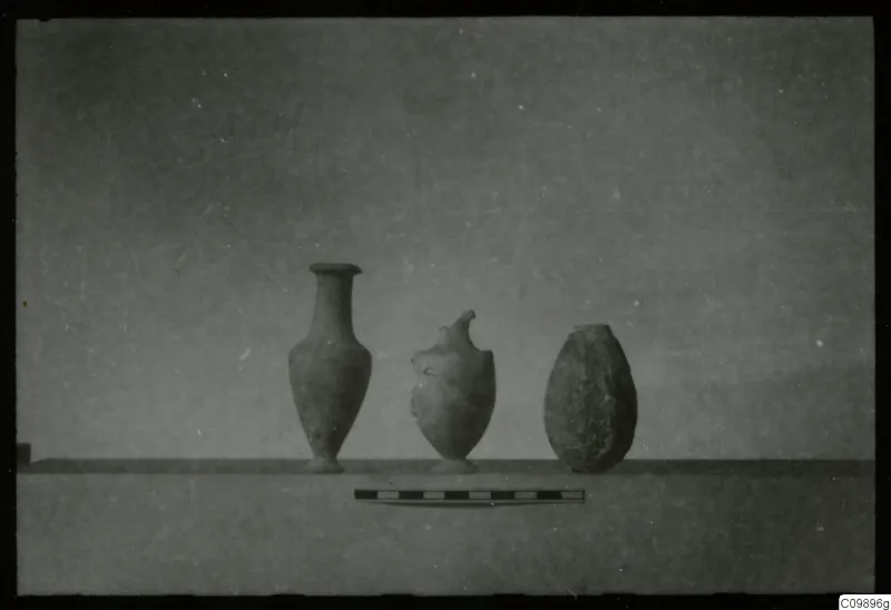Three vessels on a ledge with a scale bar in front, from Ajii Omologitades, Politiko and Limassol Oasis