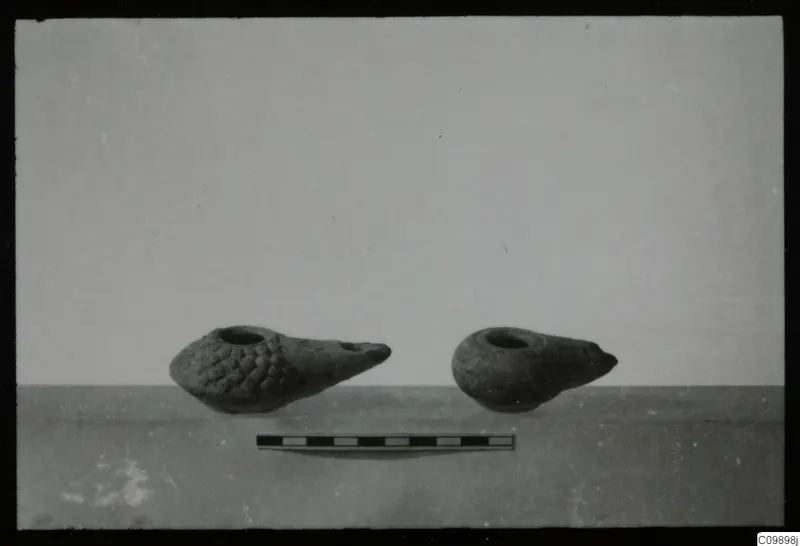 Two clay oil lamps from Politiko and Limassol Oasis standing beside a scale bar