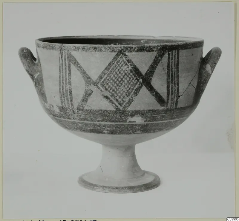 White Painted II pottery bowl on a high foot, with two handles and dark painted bands and lattice motifs.