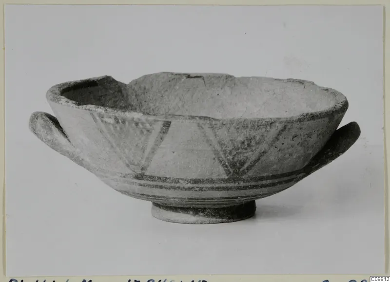 Pottery Bichrome II bowl with two side handles, painted dark bands and triangular hatching, shown on a plain background