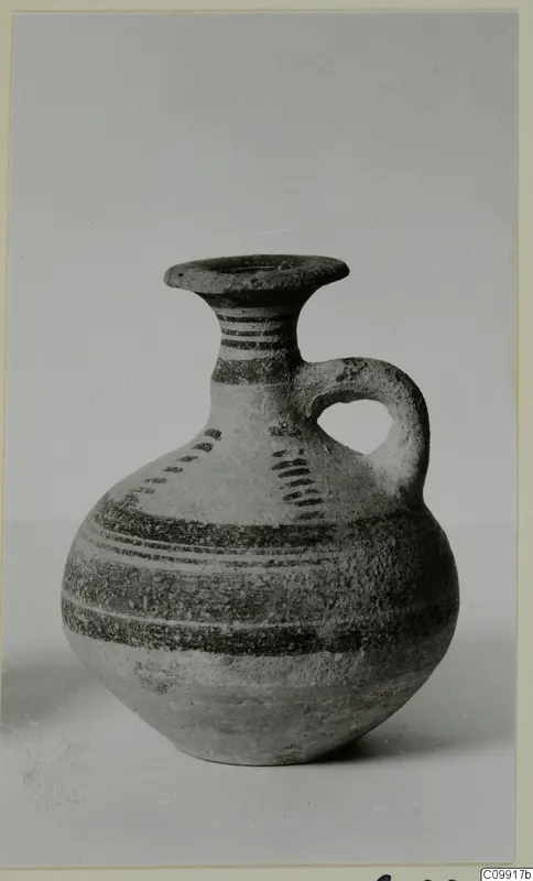 Bichrome IV jug with a single loop handle and dark painted bands, shown against a plain background