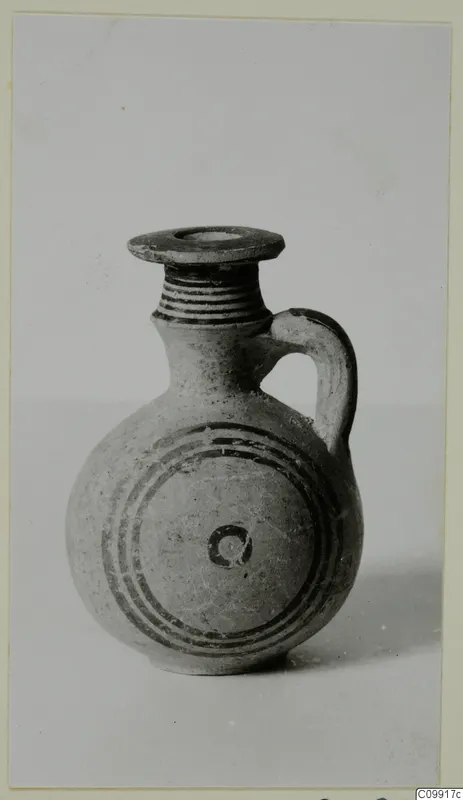 Jug with a ribbed neck, a single loop handle and dark concentric bands painted around its body