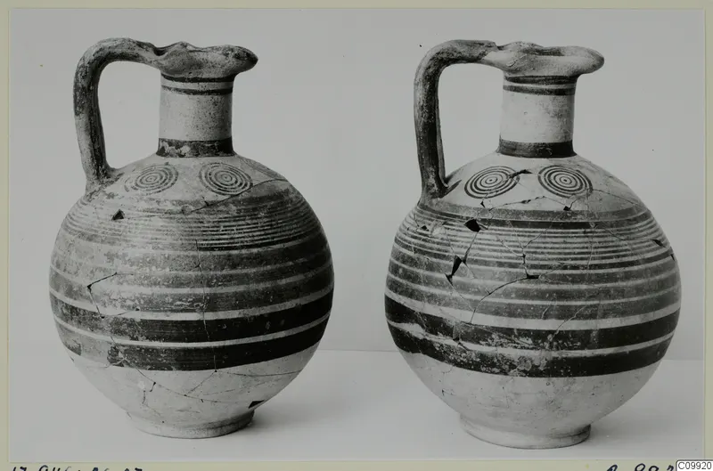 Two jugs with strap handles and banded decoration, standing side by side