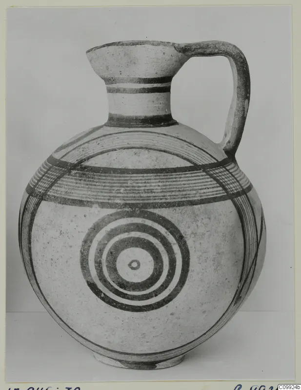 Pottery White Painted IV jug with a high loop handle and concentric circles painted on its round body