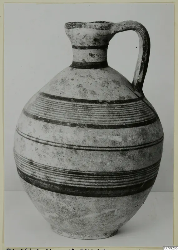 White Painted IV jug with a single loop handle and bands of dark painted lines around its body.