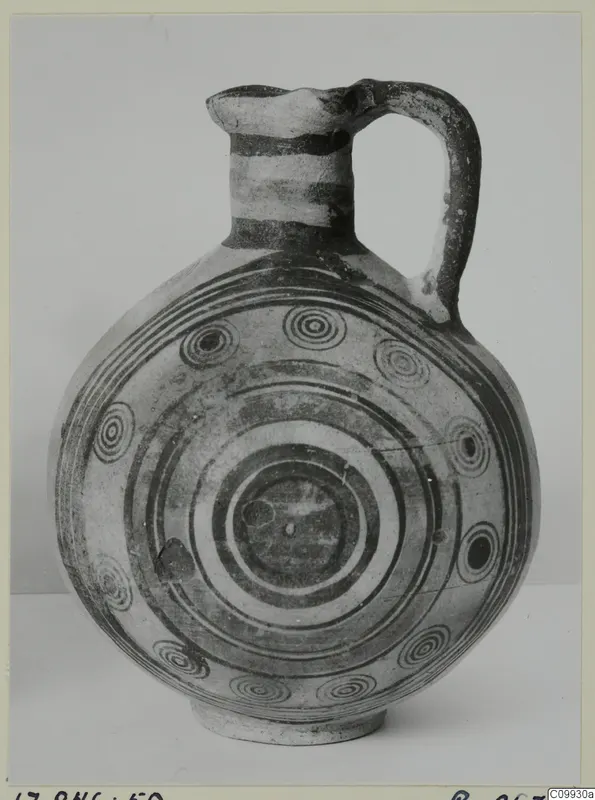 Pottery Bichrome IV jug with a globular body, strap handle and concentric circle decoration