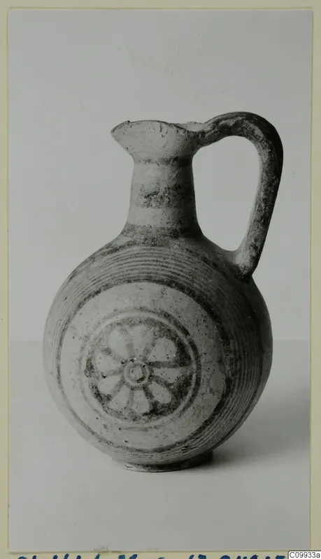 Bichrome V jug with a single handle and a rosette painted on its body