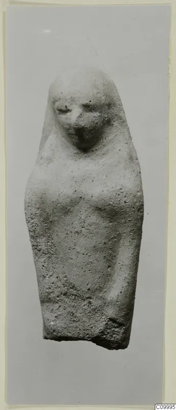 Terracotta figurine of a standing female figure with a covered head and arms close to the body.