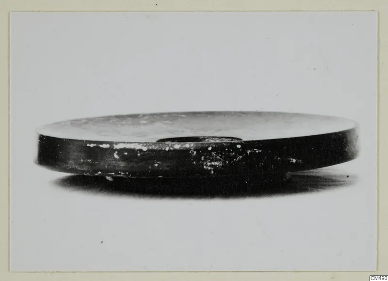 Black Glazed Ware bowl seen from the side against a plain background