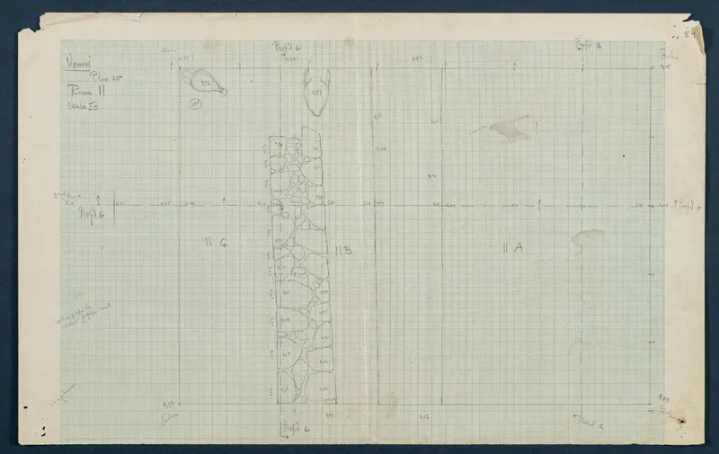 Field drawing of Room 11 at Vouni: pencil plan on squared paper showing a rubble wall and two marked finds.
