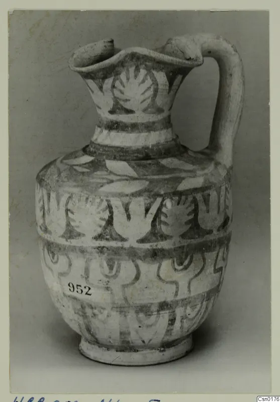Painted pottery jug with a strap handle and bands of stylised plant motifs