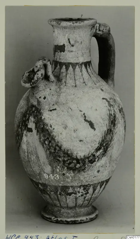 Painted pottery jug with a strap handle and a small applied lug on the shoulder