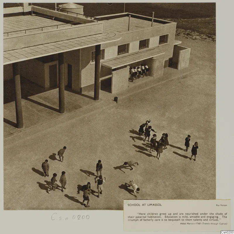 School at Limassol: children in a paved courtyard beside a flat-roofed building with round columns