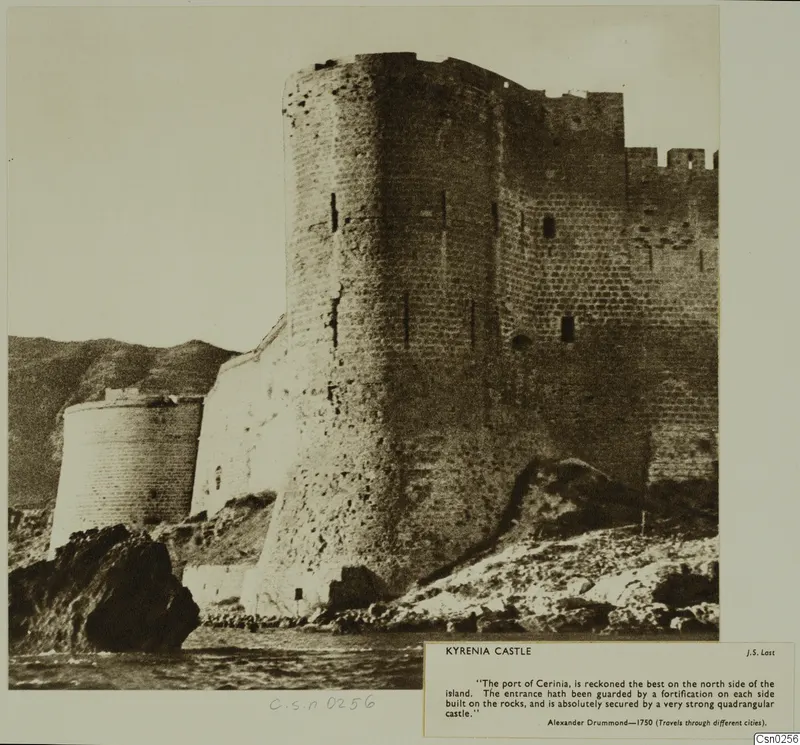 Kyrenia Castle seen from the sea, with a tall round tower and crenellated walls rising above rocks