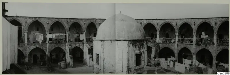 Courtyard of a building in Nicosia with arcaded galleries, a central dome and washing lines
