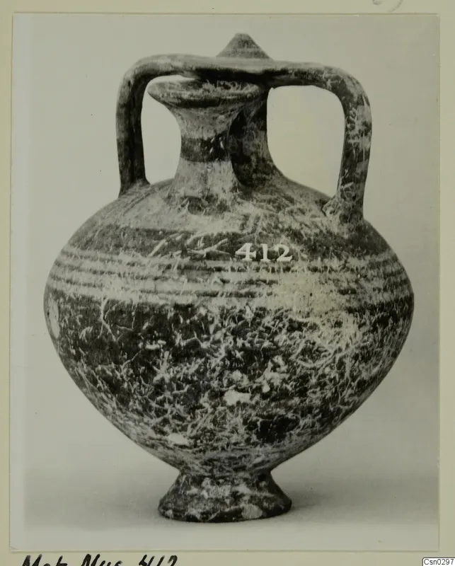 White Painted I jug with a trefoil-like mouth, two loop handles and a footed base, shown against a plain background