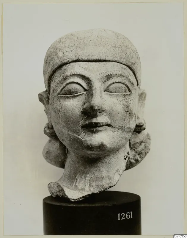 Limestone Neo-Cypriote head sculpture on a dark cylindrical stand