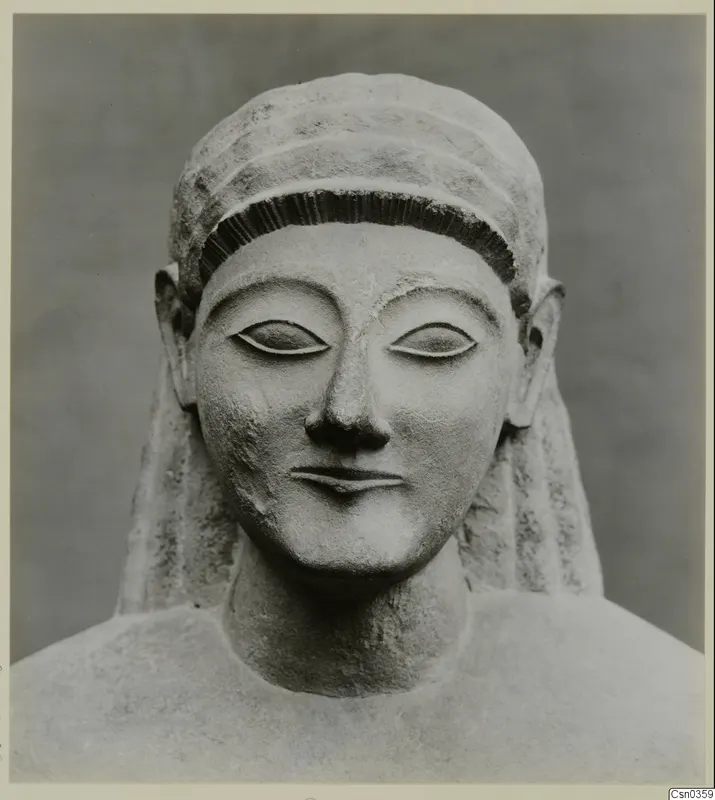 Front view of a limestone Neo-Cypriote statue head and upper torso