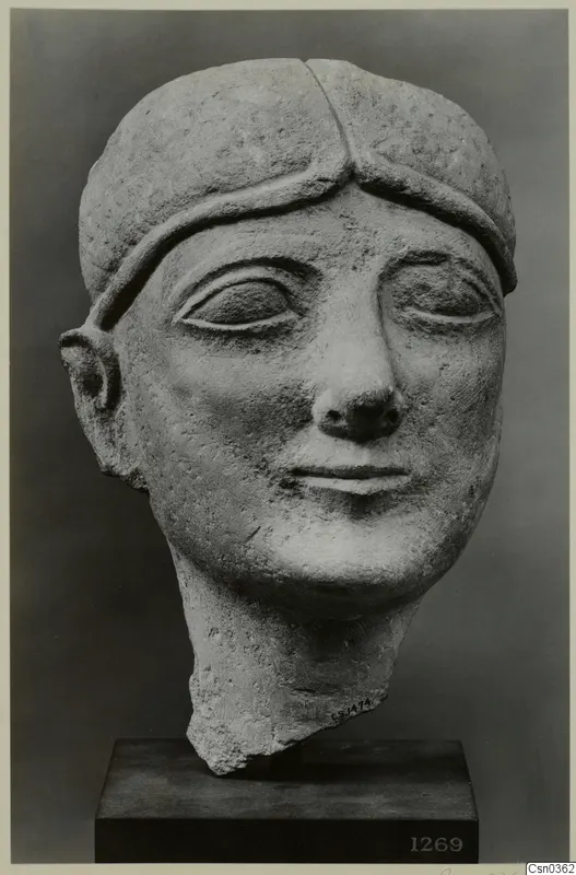 Limestone head of a figure, Neo-Cypriote, with a band across the forehead and a broken neck.