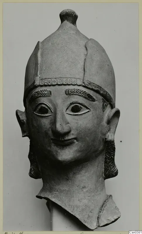 Terracotta head with a tall cap, incised eyebrows and a slight smile, seen from the front