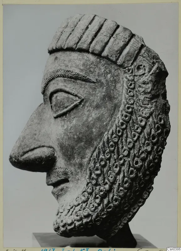 Terracotta head in profile from Dali, with a ringlet beard and grooved headdress