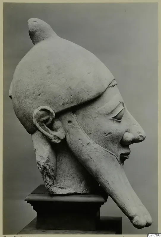 Limestone Proto-Cypriote statue head in profile, with a tall cap and a long projection from the chin.
