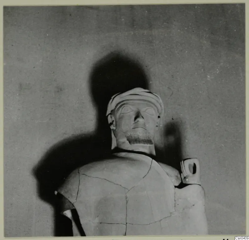 Terracotta Proto-Cypriote II, head and upper torso of a large statue with a wrapped headdress and mended cracks