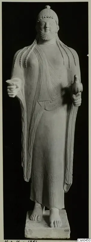 Limestone statue of a standing bearded figure holding a small bird.