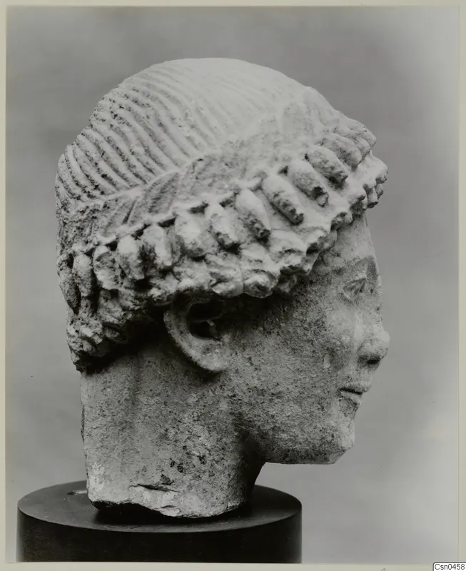 Limestone Cypro-Greek I head in profile on a dark stand, with incised hair and rows of locks.