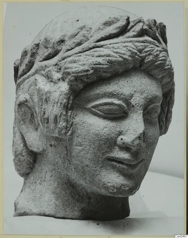 Limestone head with a leafy band in its hair, from Mersinaki, shown in three-quarter view