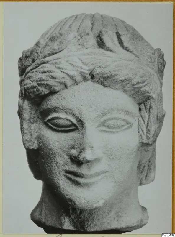 Limestone head from Mersinaki with wavy hair, almond-shaped eyes and a faint smile