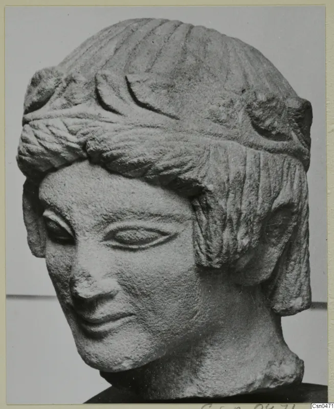 Limestone head sculpture from Mersinaki, three-quarter view, with hair bound by a broad band.