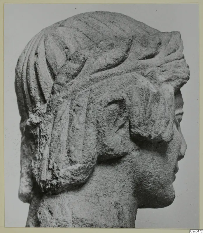 Limestone head in profile from Mersinaki, facing right, with grooved hair and a headdress