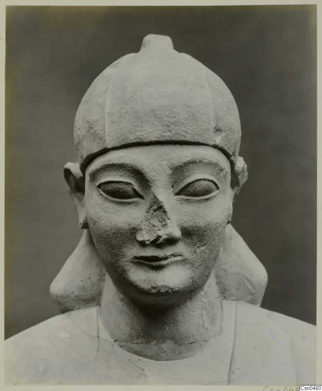 Limestone Neo-Cypriote bust of a figure in a rounded cap, face and shoulders shown against a dark backdrop
