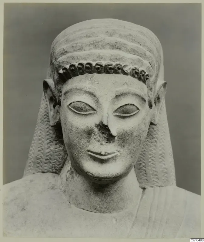 Limestone Neo-Cypriote bust with a curled band across the forehead and long side locks, nose broken