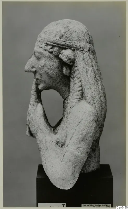 Limestone bust of a figure in profile with one hand raised to the chin.