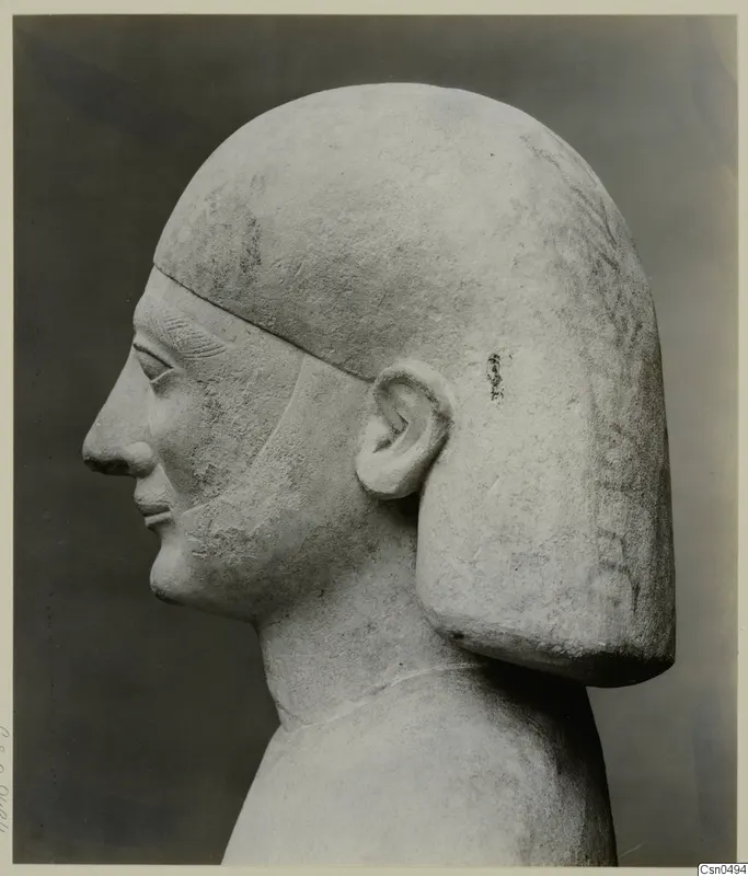 Limestone Cypro-Egyptian bust in profile, facing left, with a squared hair block falling behind the ear.