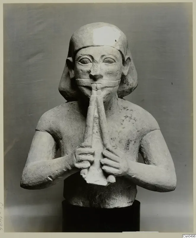 Limestone sculpture of a seated figure playing a double pipe, Cypro-Egyptian
