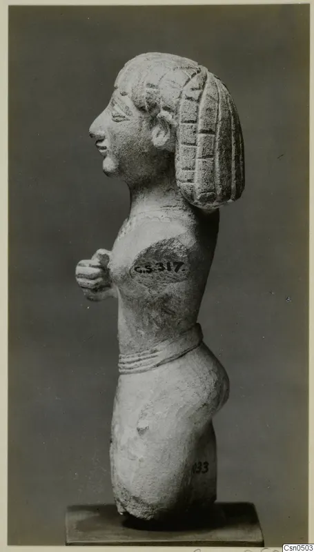 Limestone Cypro-Egyptian standing female figure in side profile, hands at chest, on a square base