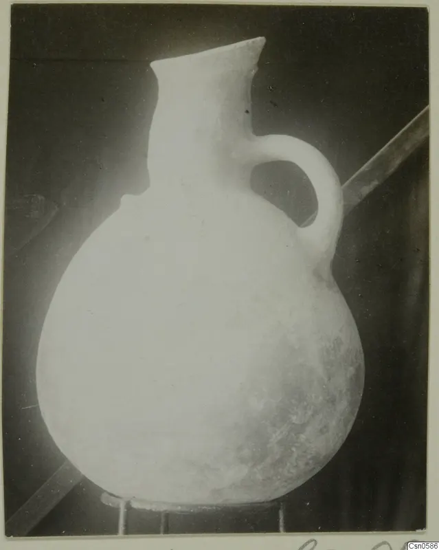 Round-bodied jug with a flared neck and a single loop handle.