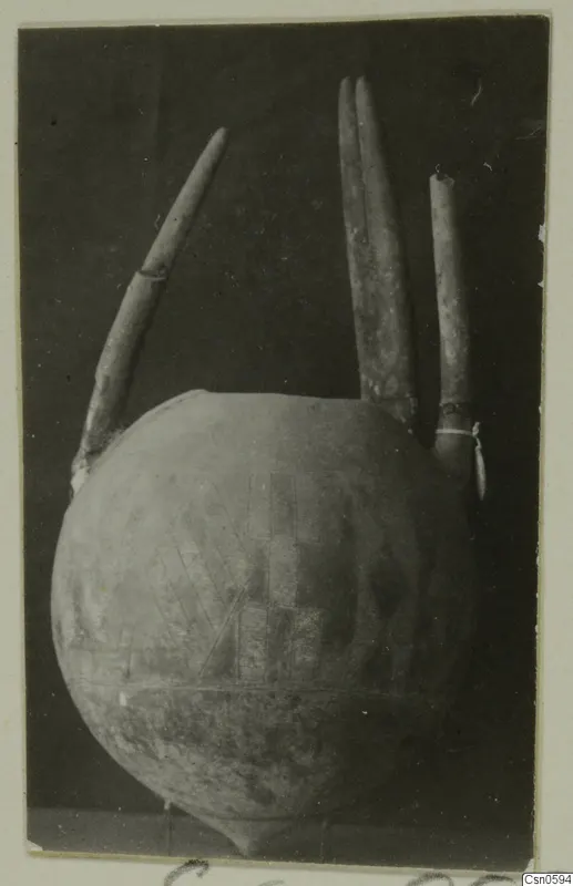 Round-bodied vessel with three tall tubular projections and an incised hatched and grid pattern on its body