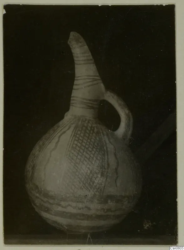 Pottery jug with a long narrow neck, single loop handle and painted bands and cross-hatching on the body