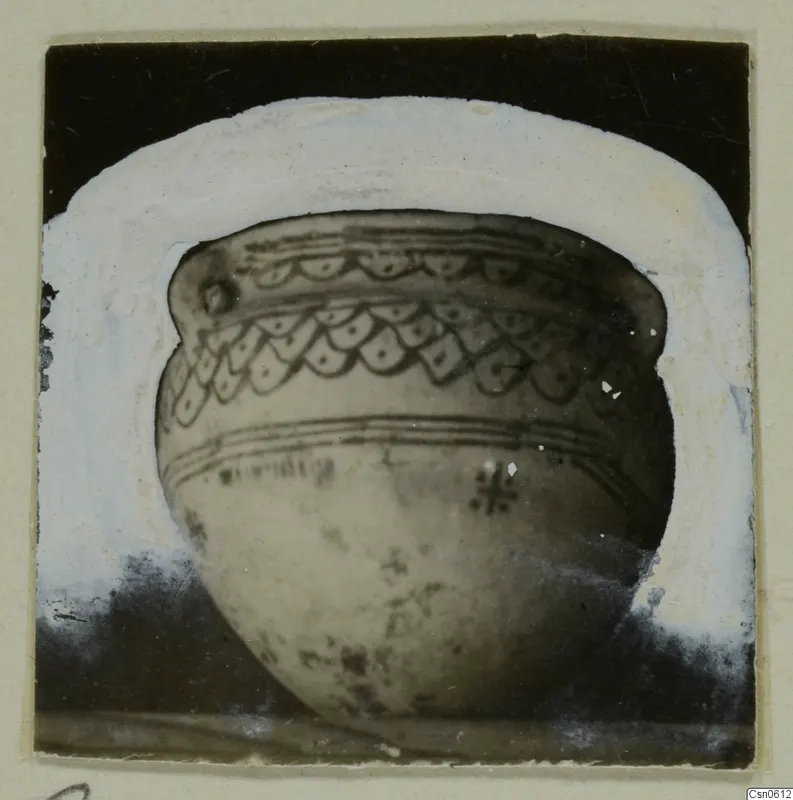 Rounded bowl with bands of scalloped pattern and parallel lines, shown against a dark background