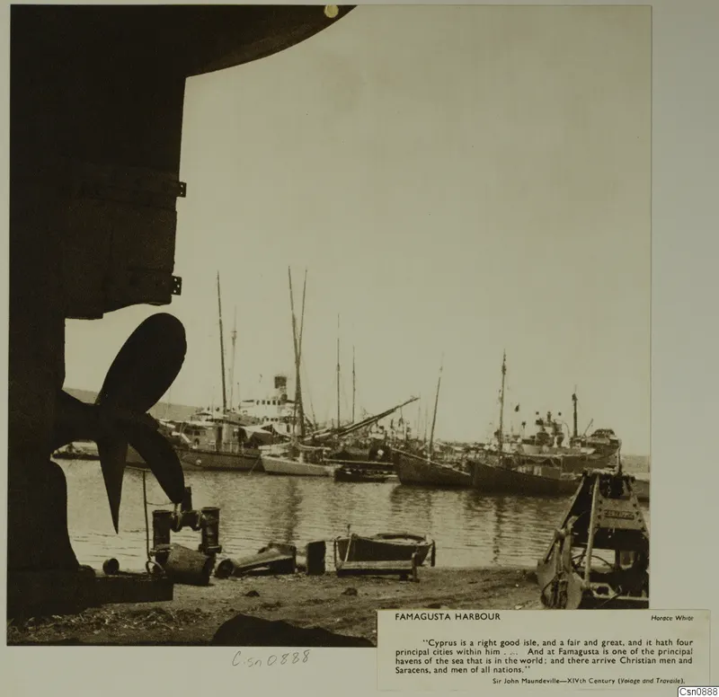 Famagusta harbour with moored sailing boats and steamships, and a ship's propeller in the foreground