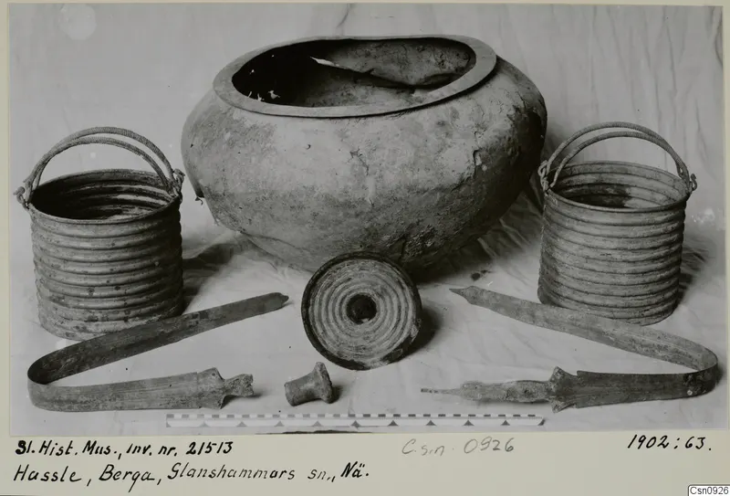 Pails and pot from Hassle, Berga, Glanshammar parish, arranged on a light cloth.