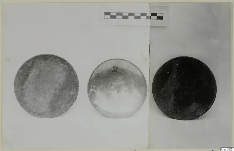 Three round, dish-like objects from Arsos, shown side by side with a scale bar above them
